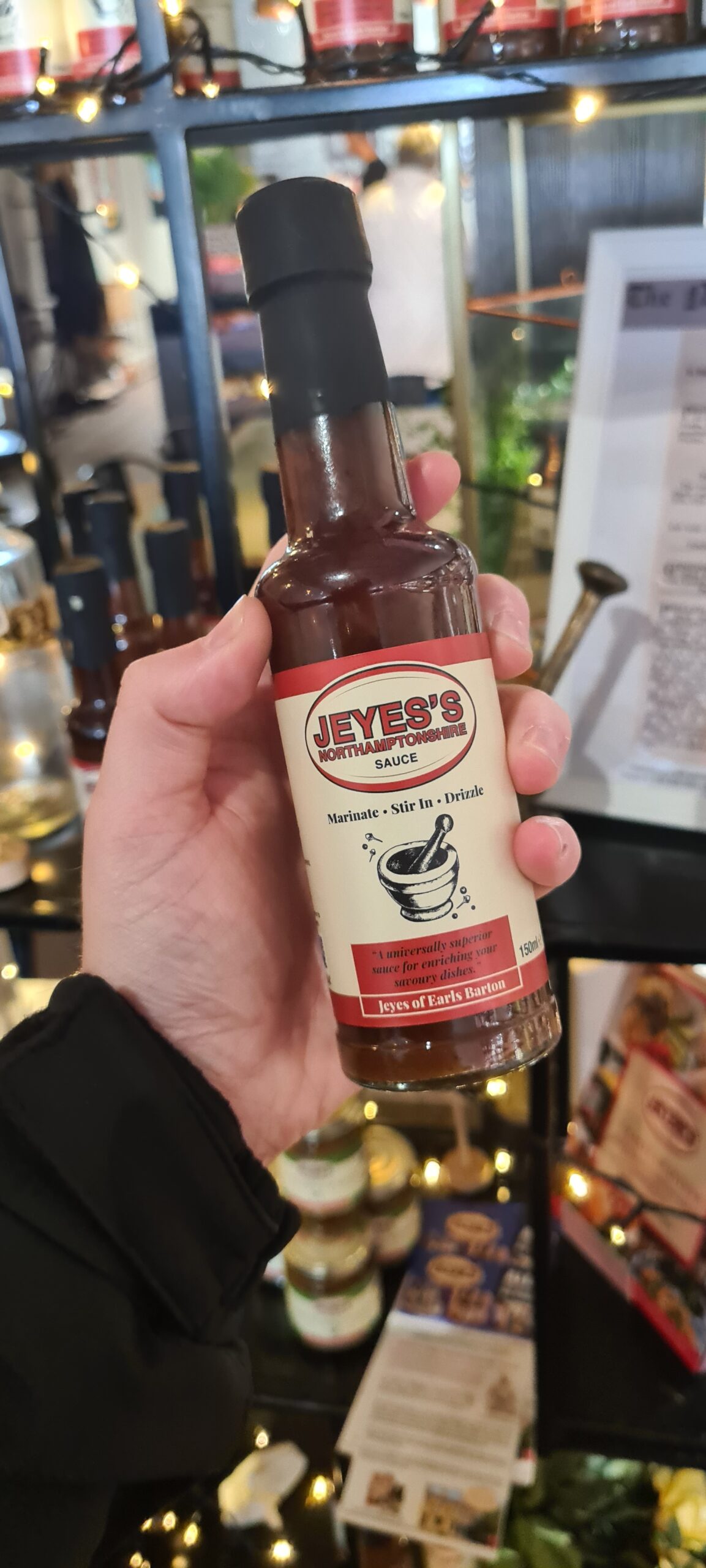 IMAGE: Jeyes's Northamptonshire Sauce. A dark brown bottle with a beige label. Red accents and a mortar and pestle sketch.