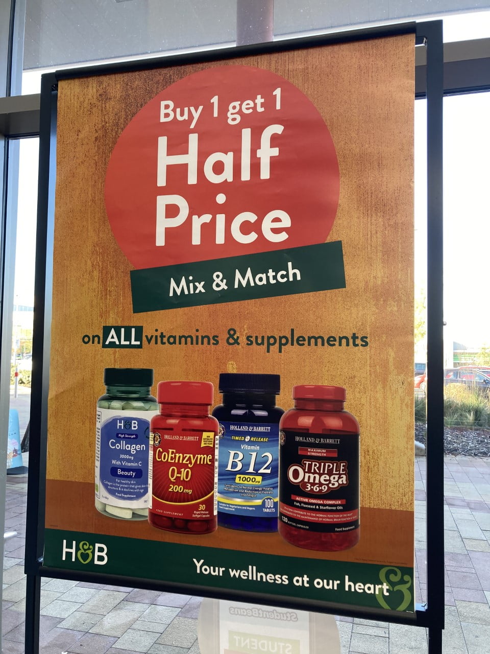 IMAGE: A window display featuring the above offer. With various products on a orange background.